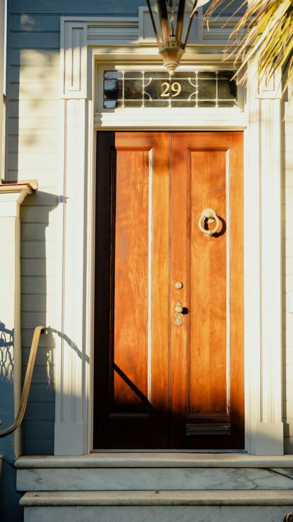 Classic Wooden Front Door with Elegant Architectural Details Wallpaper