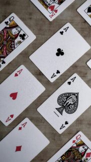 Close-up Poker Playing Cards Spread on Wood Table Wallpaper