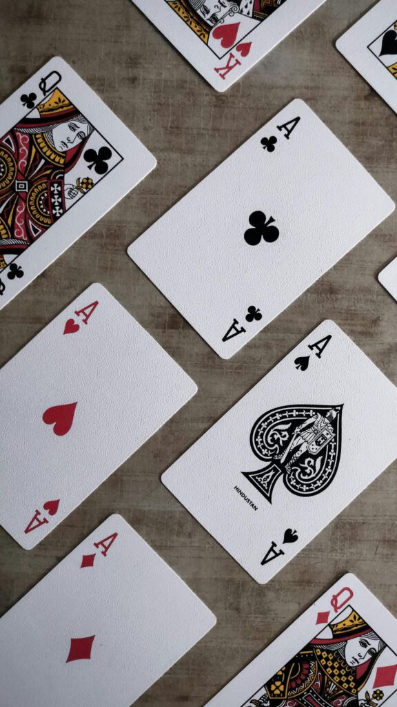 Close-up Poker Playing Cards Spread on Wood Table Wallpaper
