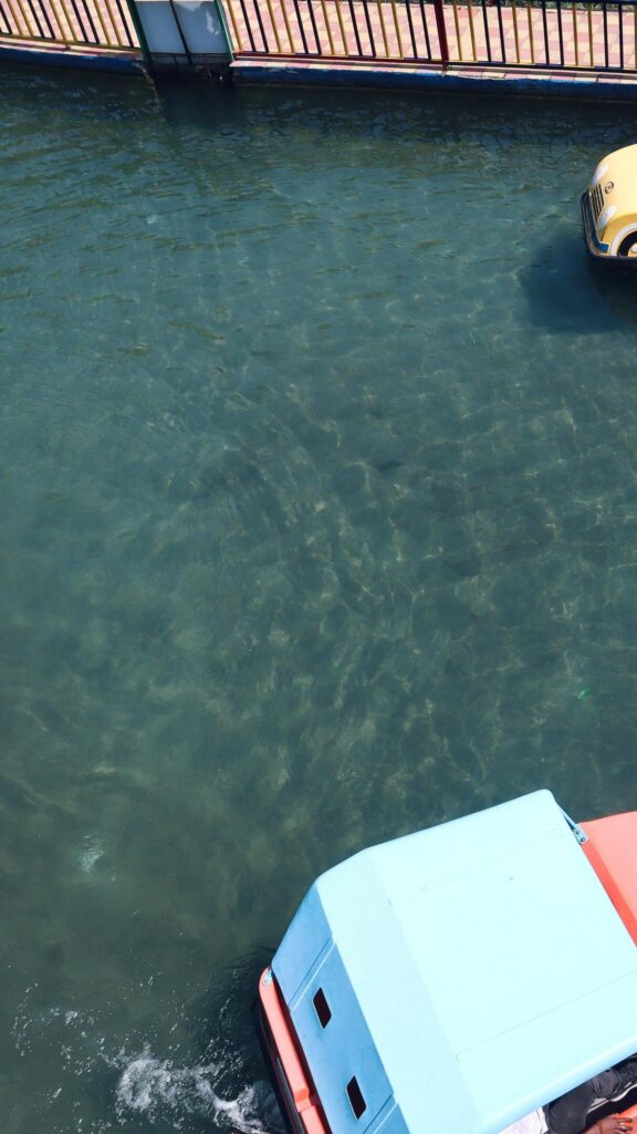 Top-Down View of Pedalo Boats on Clear Blue Water Wallpaper