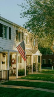 Charming Suburban Home with American Flag Golden Hour Phone Wallpaper