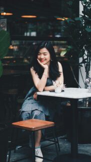 Beautiful Asian Girl Smiling at Cafe Table Aesthetic Phone Wallpaper