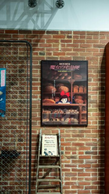 Kiki's Delivery Service Poster on Brick Wall Cinematic Wallpaper