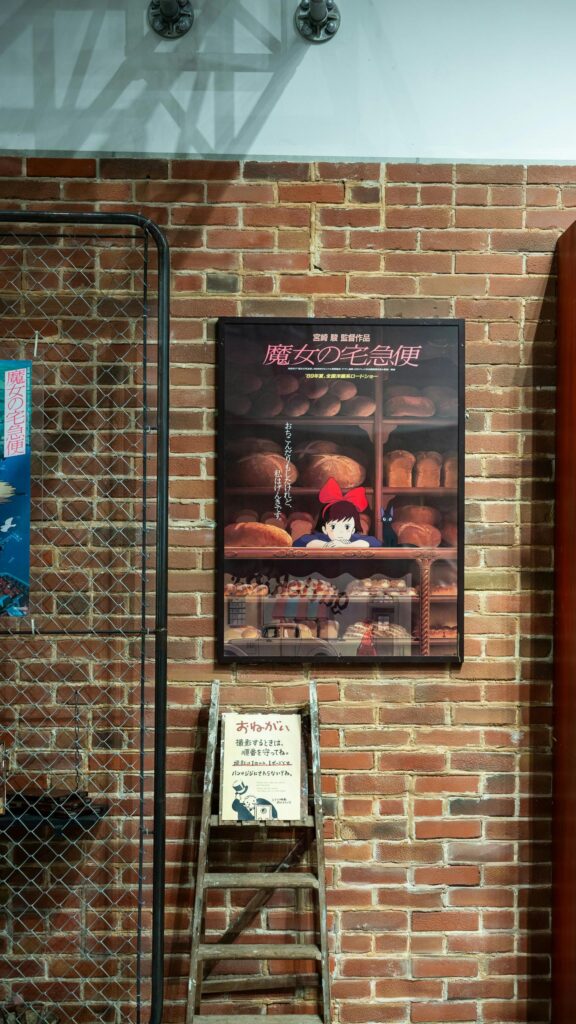 Kiki's Delivery Service Poster on Brick Wall Cinematic Wallpaper