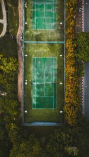 Aerial View of Tennis Courts Surrounded by Autumn Trees Mobile Wallpaper