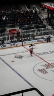 Thrilling Ice Hockey Game Action Red and White Players Wallpaper
