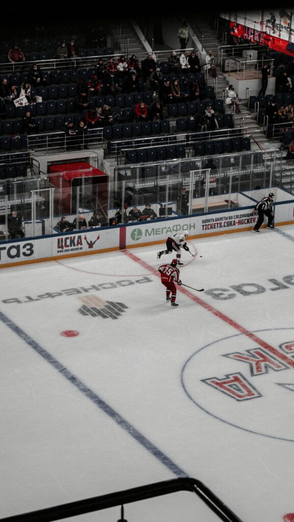 Thrilling Ice Hockey Game Action Red and White Players Wallpaper
