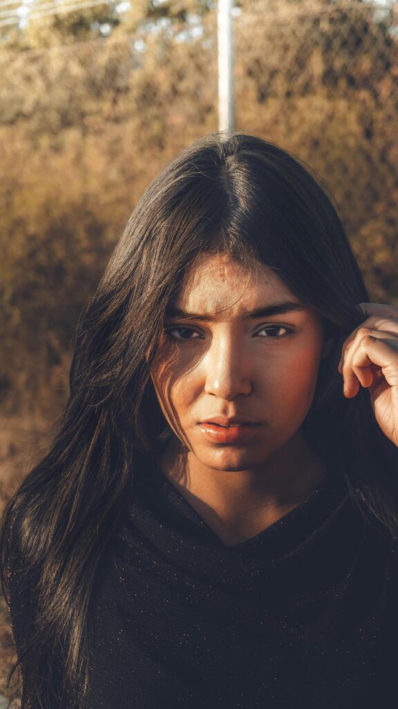 Stunning Portrait of a Young Woman with Long Dark Hair Phone Wallpaper