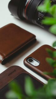 Minimalist Leather Tech Accessories and Camera Desk Setup Wallpaper
