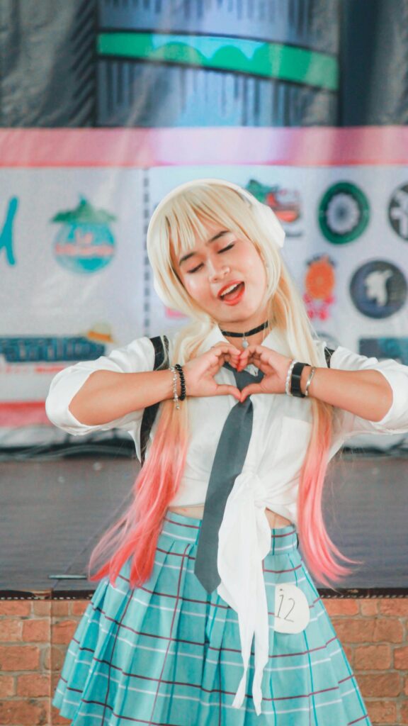 Cute Anime Cosplayer Heart Hand Gesture Mobile Wallpaper