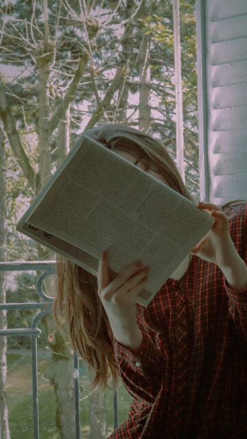 Aesthetic Girl Reading Book by the Window Mobile Wallpaper