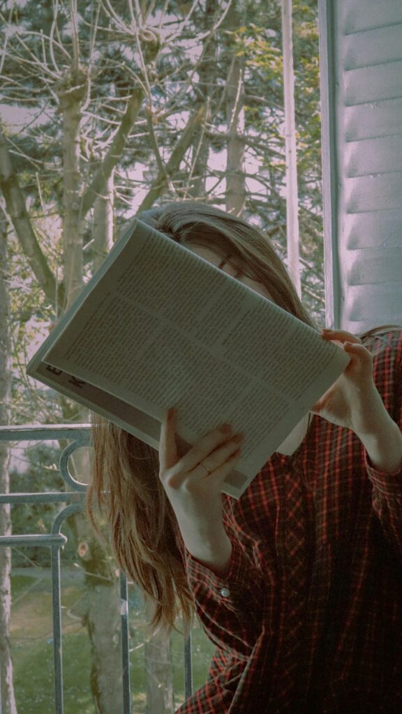 Aesthetic Girl Reading Book by the Window Mobile Wallpaper