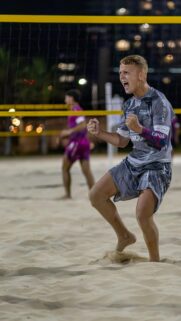 Dynamic Beach Volleyball Celebration Athlete Energy Mobile Wallpaper