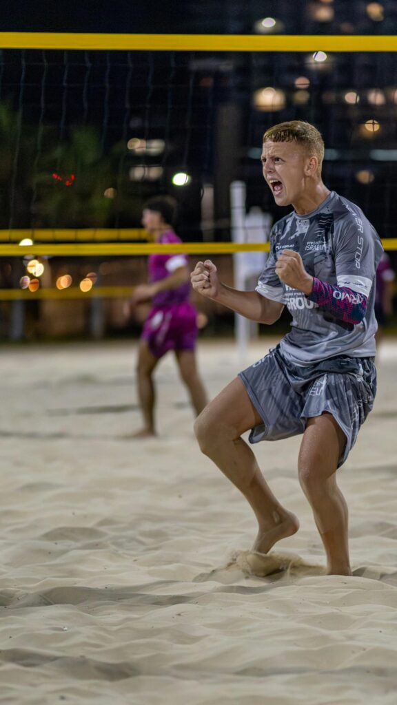 Dynamic Beach Volleyball Celebration Athlete Energy Mobile Wallpaper