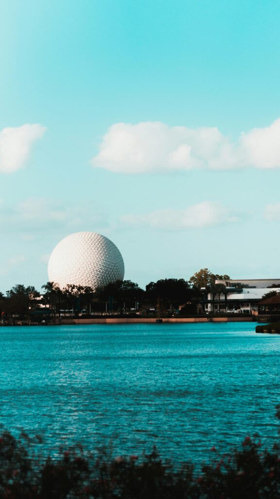 Iconic Spaceship Earth Epcot Center Scenic Lake View Mobile Wallpaper