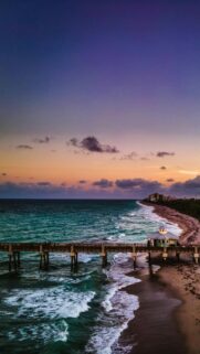 Stunning Pier at Sunset Over Ocean Waves Mobile Wallpaper
