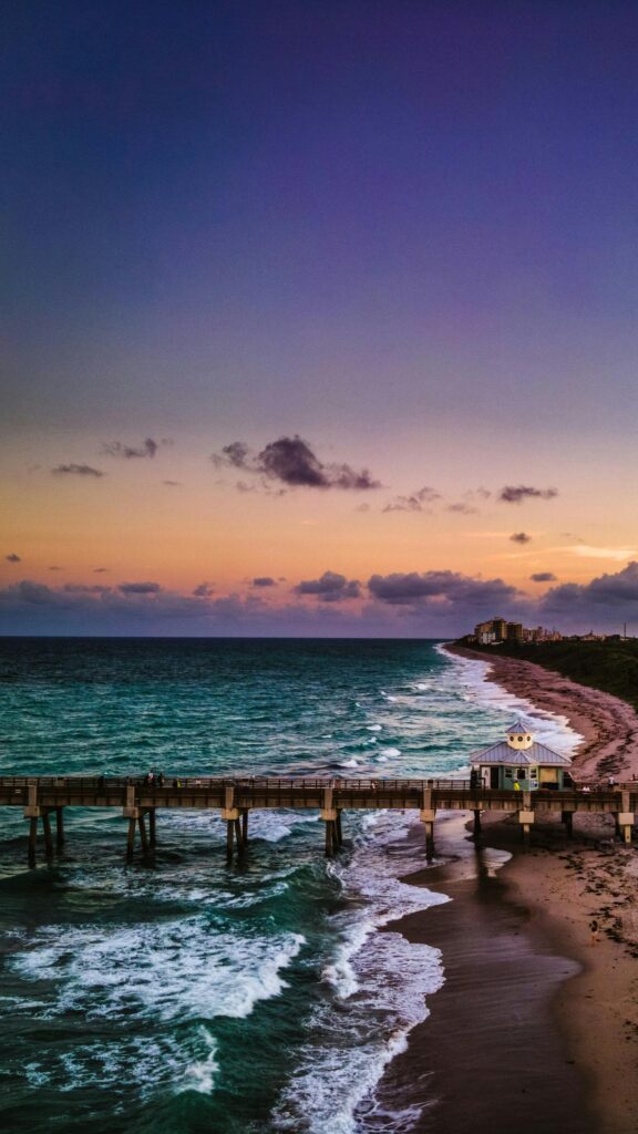 Stunning Pier at Sunset Over Ocean Waves Mobile Wallpaper
