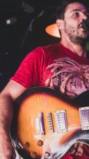 A Singer Performing Live with Electric Guitar Mobile Wallpaper