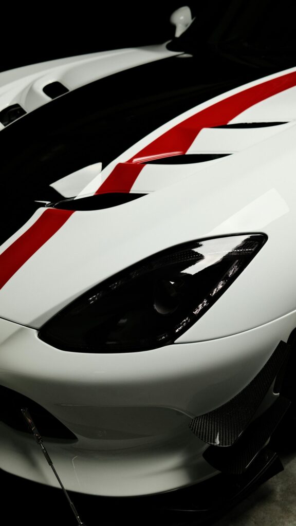 Stunning White Sports Car with Red Racing Stripes Mobile Wallpaper