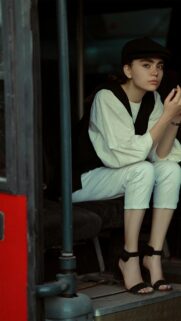 Fashionable Girl in Newsboy Cap and White Outfit Mobile Wallpaper