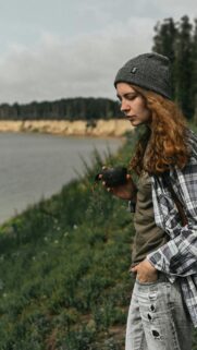 Girl with Kuksa Cup Hiking Outdoors Mobile Wallpaper