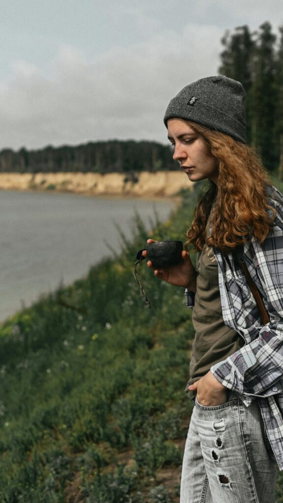 Girl with Kuksa Cup Hiking Outdoors Mobile Wallpaper