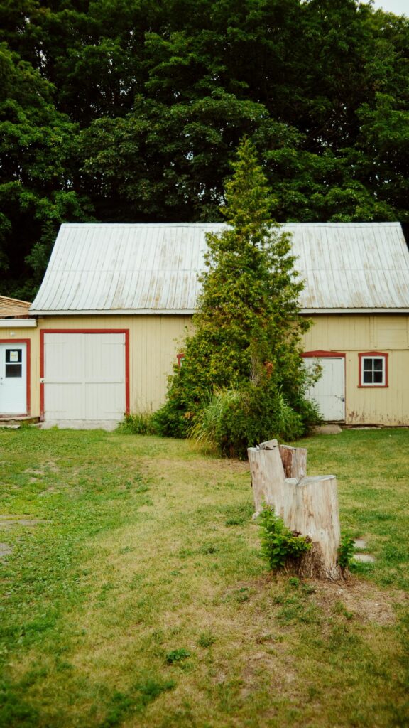 Rustic Country Barn with Tree and Wood Stump Phone Wallpaper