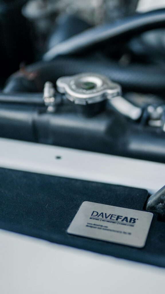 Close-up Car Engine Bay with Davefab Badge 4K Phone Wallpaper