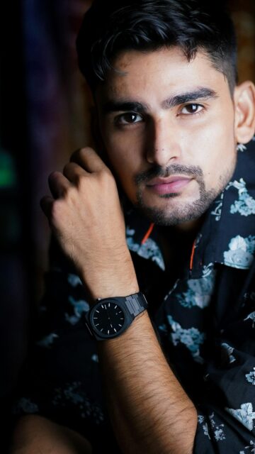 Portrait of a Handsome Man with Floral Shirt and Watch Wallpaper