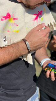 Close Up Man With Feather Bracelet and Paint Palette Artistic Mobile Wallpaper