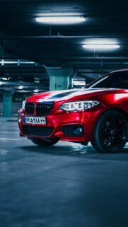 Sleek Matte Red BMW 2 Series Sports Car Parking Garage Wallpaper