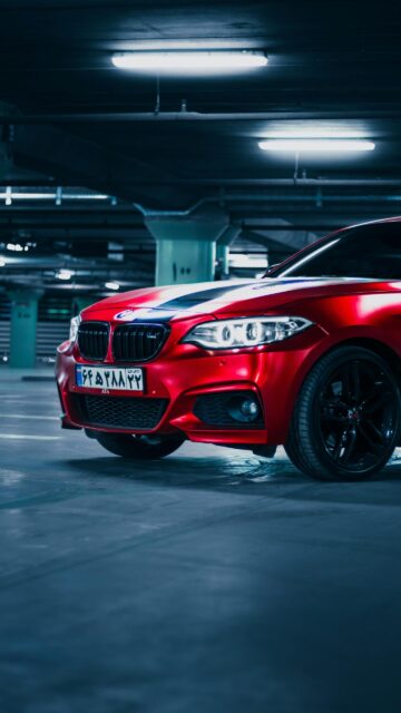 Sleek Matte Red BMW 2 Series Sports Car Parking Garage Wallpaper
