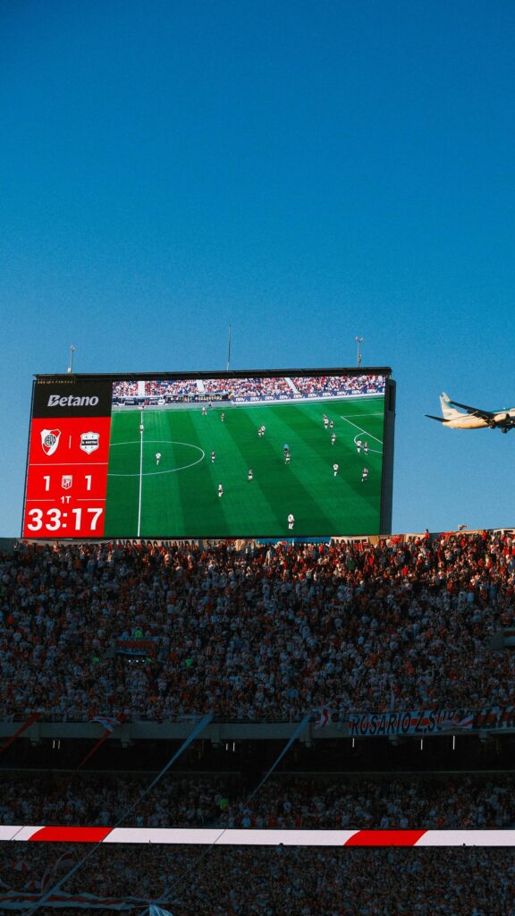 Stunning River Plate Stadium View with Airplane Mobile Wallpaper