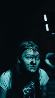 Horror Girl with Black Paint and Glowing White Eyes Mobile Wallpaper