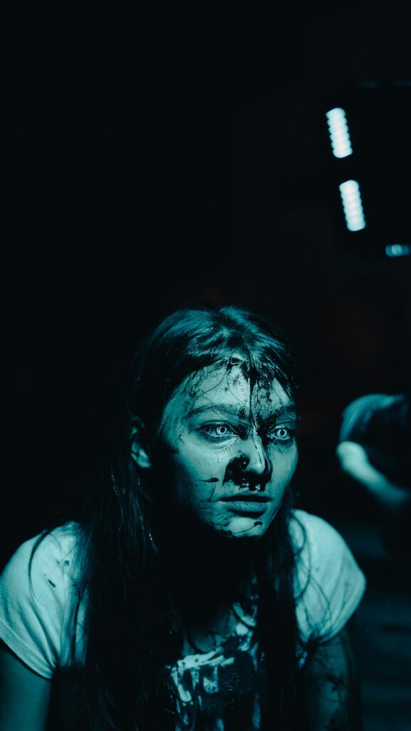 Horror Girl with Black Paint and Glowing White Eyes Mobile Wallpaper