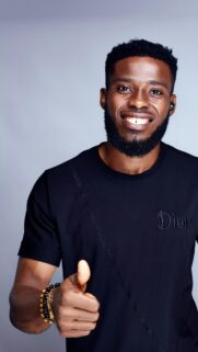 Smiling Man in Dior T-shirt Giving Thumbs Up Mobile Wallpaper