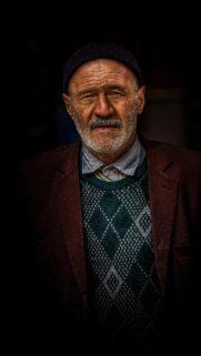 Elderly Man in Traditional Attire Portrait Mobile Wallpaper