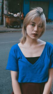 Stunning Portrait of an Asian Woman in a Blue Top Mobile Wallpaper
