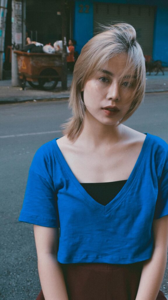 Stunning Portrait of an Asian Woman in a Blue Top Mobile Wallpaper