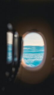 Airplane Window View Above Clouds Aesthetic 4K Phone Wallpaper