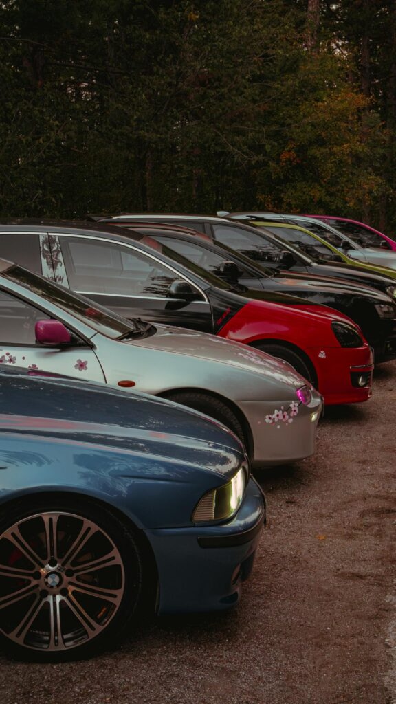 Stunning Lineup of Tuned Sports Cars in Forest Park Wallpaper