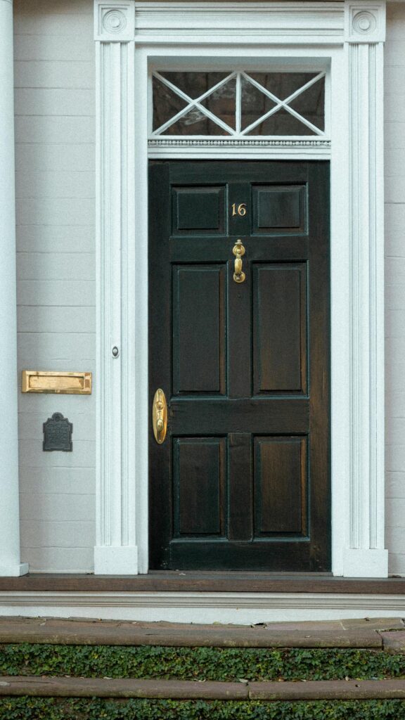 Classic Black Front Door with Gold Accents Elegant Phone Wallpaper