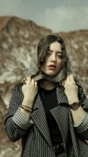Elegant Woman in Patterned Scarf and Blazer Portrait Wallpaper