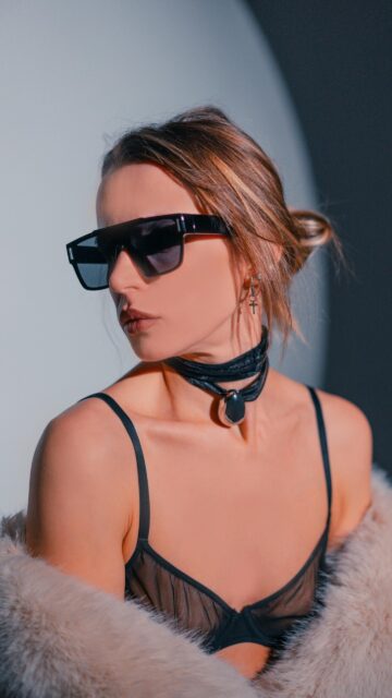 Stylish Woman in Faux Fur and Designer Sunglasses Fashion Wallpaper