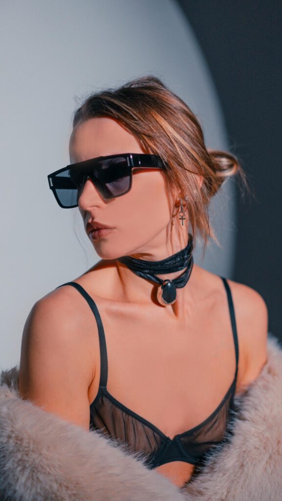 Stylish Woman in Faux Fur and Designer Sunglasses Fashion Wallpaper