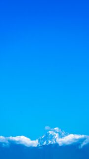 Majestic Snowy Mountain Peak Above Fluffy Clouds Phone Wallpaper