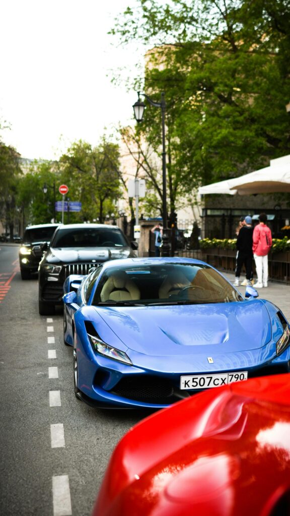 Blue Ferrari F8 Tributo Sports Car on City Street Mobile Wallpaper