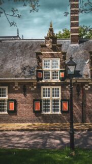 Dutch Brick House Architecture with Street Lamp Phone Wallpaper