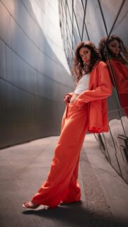 Stylish Woman in Orange Suit Urban Fashion Mobile Wallpaper