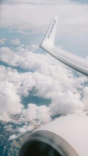 Stunning Ryanair Airplane Wing Over Snowy Mountains Cloudscape Wallpaper